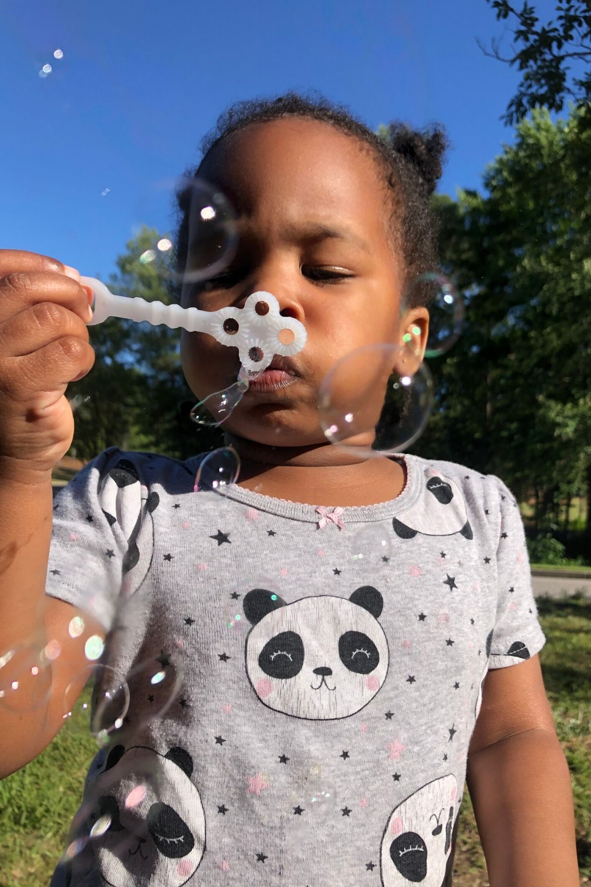 girl blowing bubbles having some outdoor fun