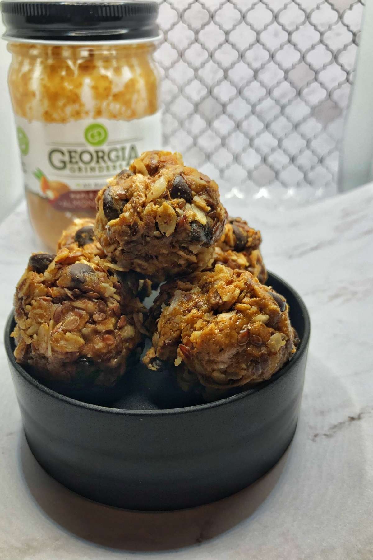 A bowl of no bake energy balls in a bowl on a counter