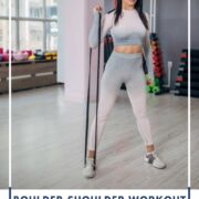 woman doing upper body resistance band shoulder workout in gym