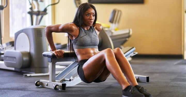 woman doing bench dips restarting to work out again after time off
