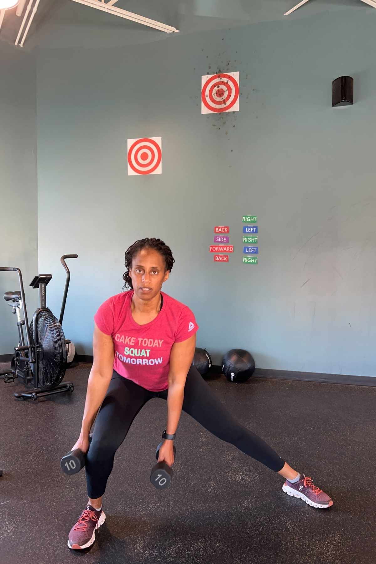 woman doing side lateral lunge with dumbbells