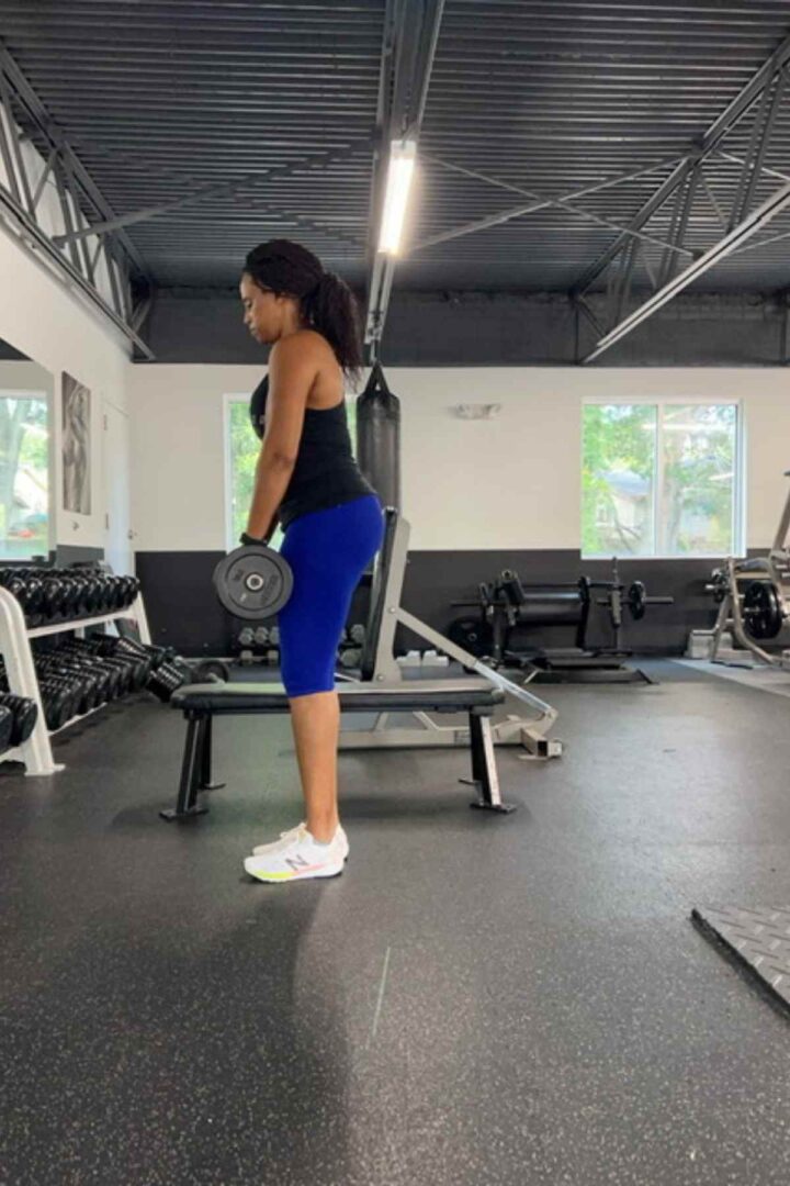woman standing at the top of single leg deadlift