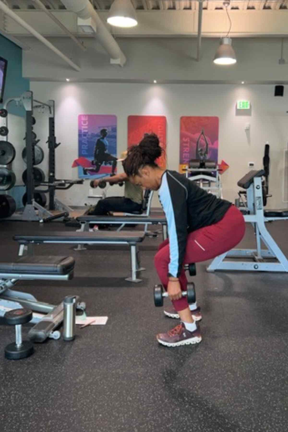woman doing squats for dumbbell glute exercises