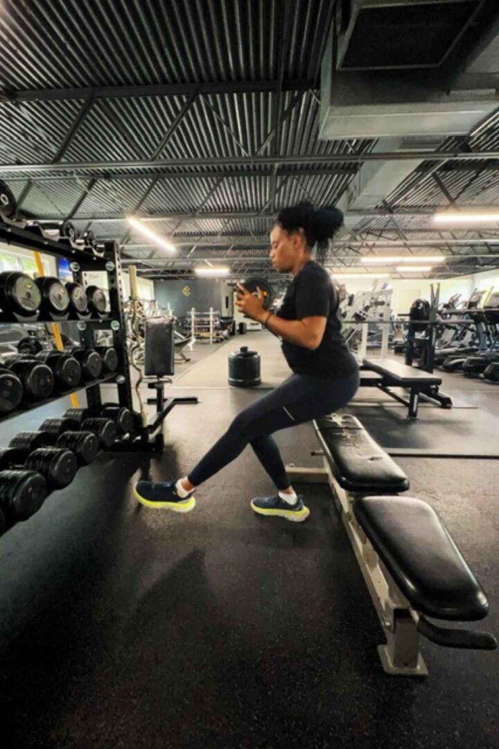 woman doing single leg squat exercises in the gym