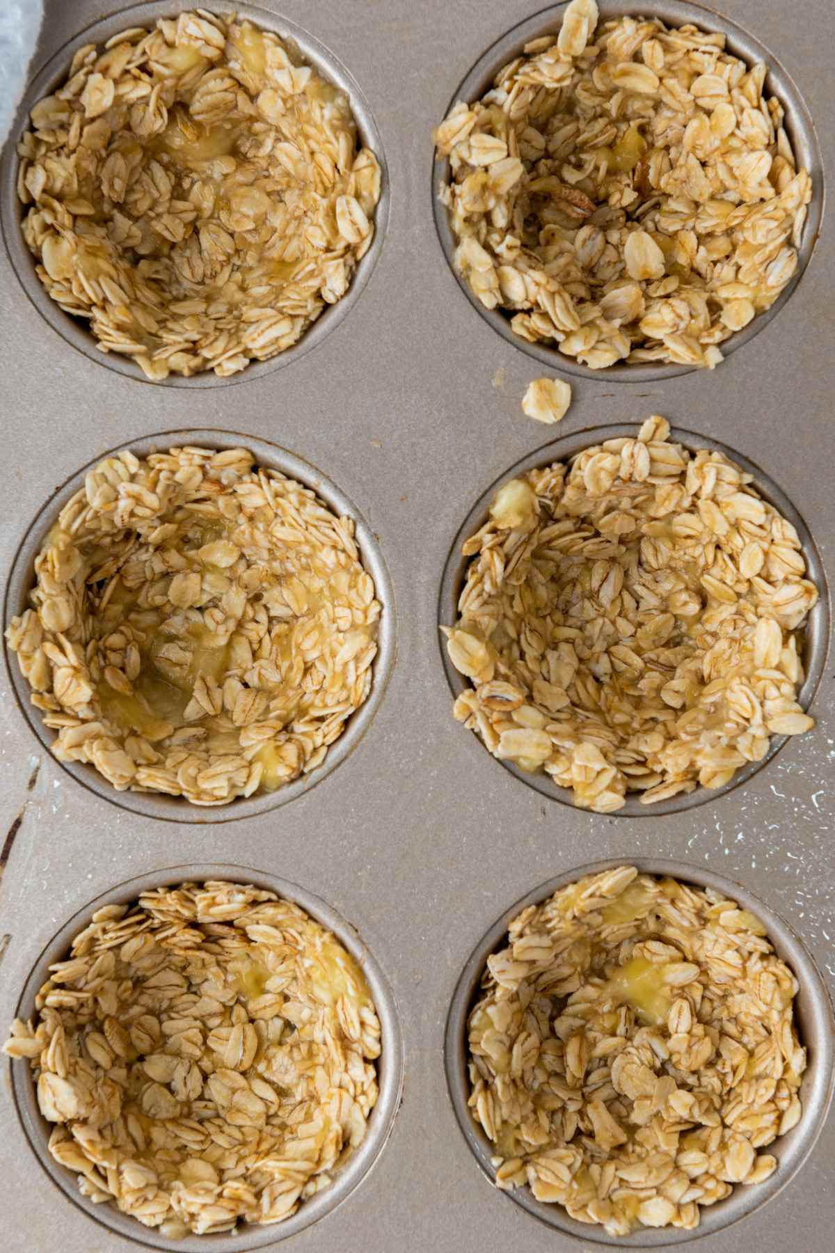 unbaked granola cups in a muffin pan