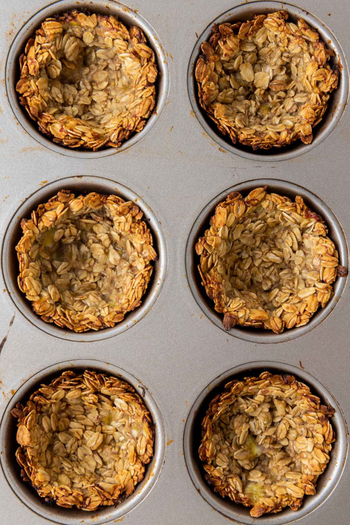 unbaked granola cups in a muffin pan