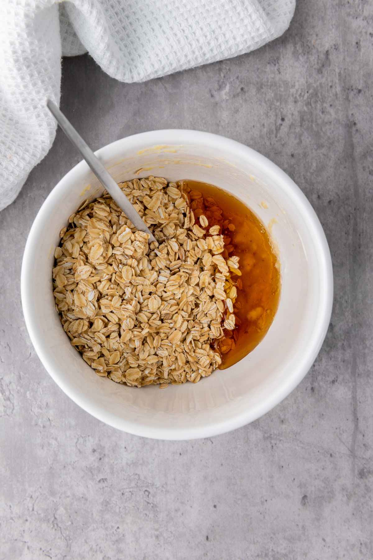 oats , honey  and mashed banana in a bowl on a counter