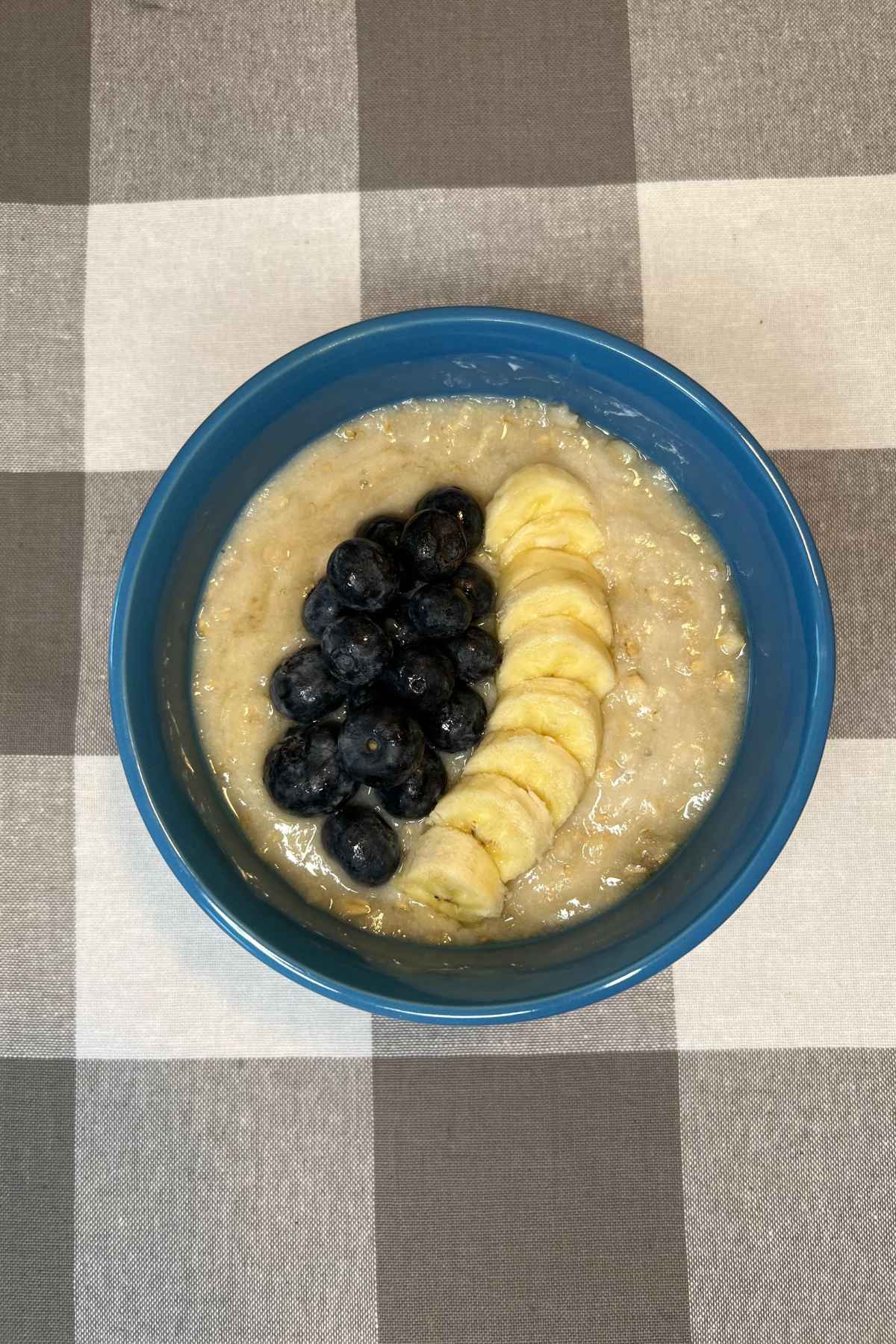 bowl of oatmeal with berries and bananas