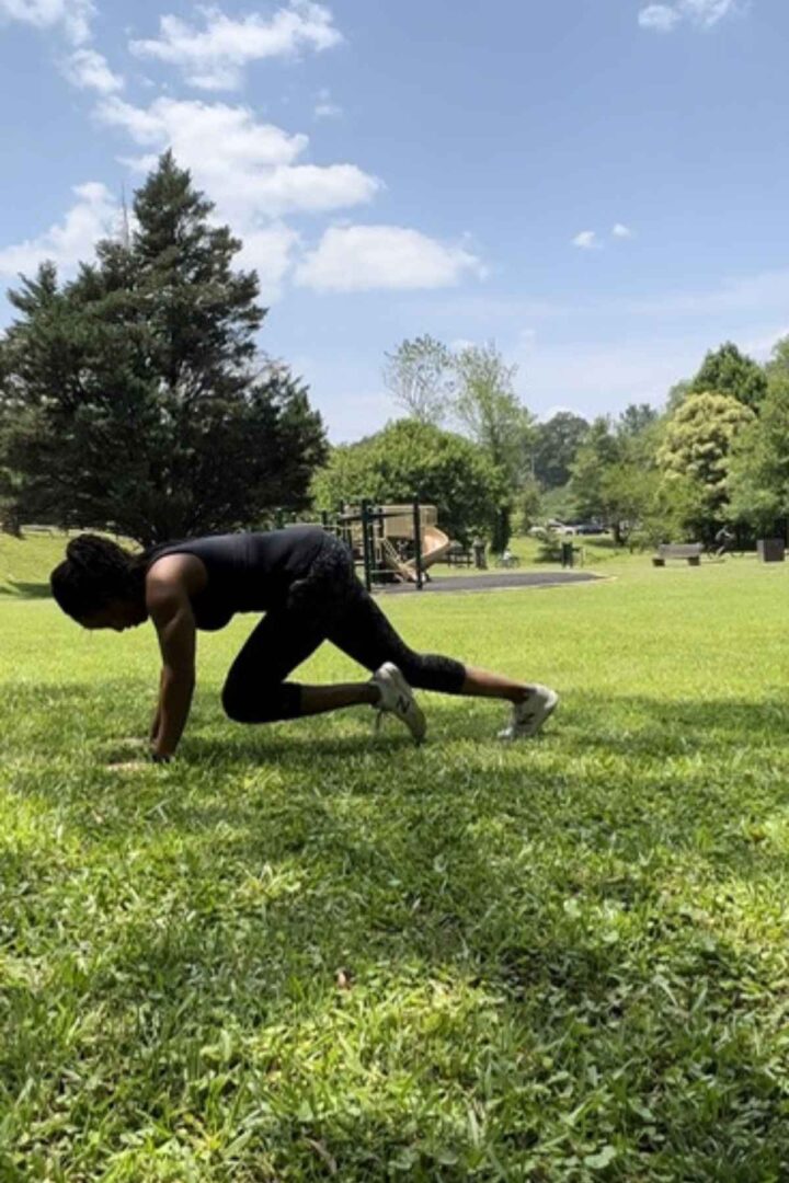 woman doing mountain climbers in the park. they are a great beginner no equipment core exercise