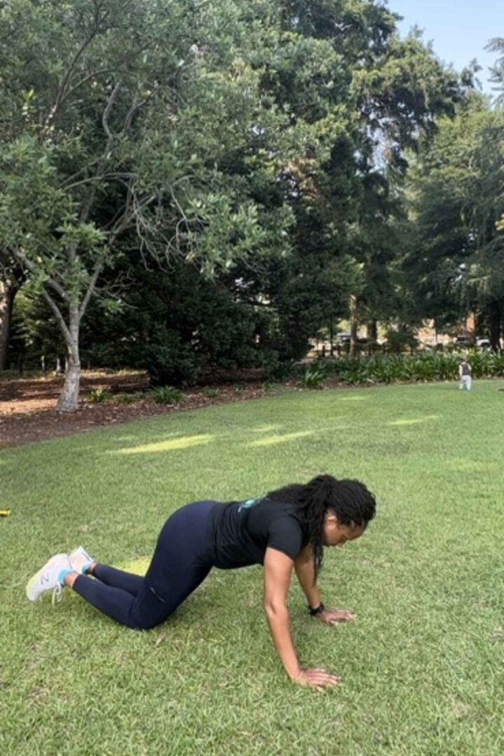 woman outside doing push ups for advanced bodyweight EMOM workout