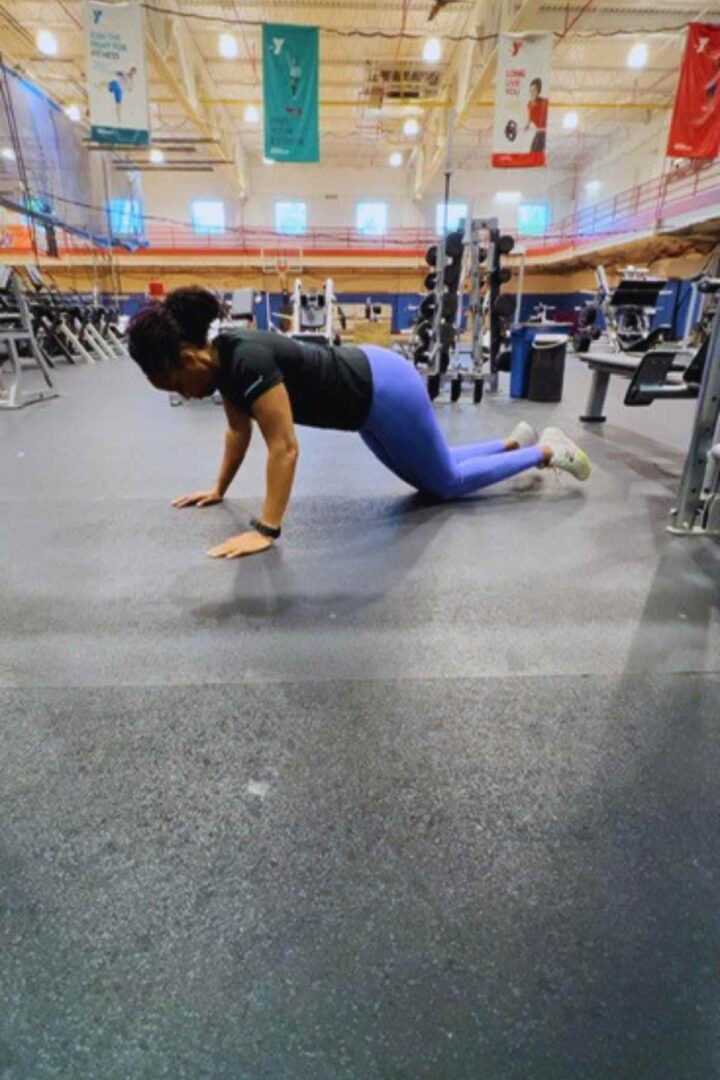woman doing push ups for a shoulder and abs workout