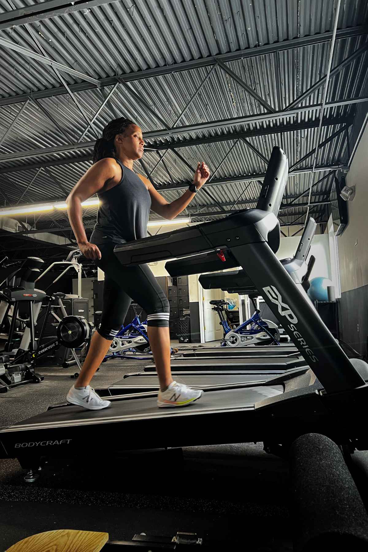 woman walking on incline in a treadmill